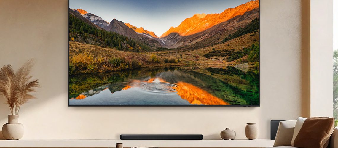 The 115-inch Samsung QN90F Neo QLED TV in a beige living room.