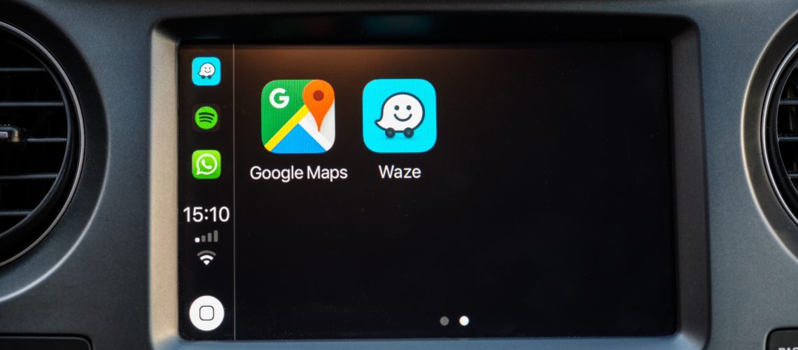 Google Maps and Waze icons on a car dashboard