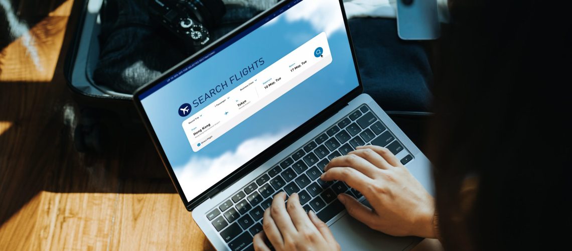Person searching for flights on a laptop