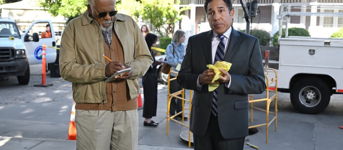 L-R: Barry (Duane Shepard Sr.) and Oscar (Oscar Nunez) standing on a street in a scene from Peacock's The Office" spinoff, "The Paper"