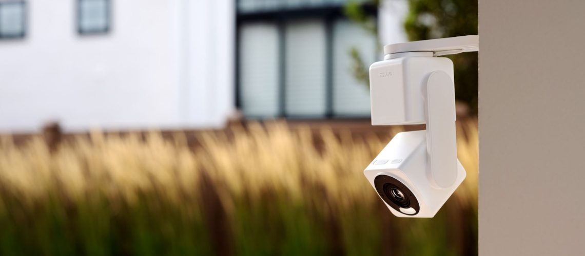Wyze Cam Pan v4 attached to the exterior of a house with a yard in the background