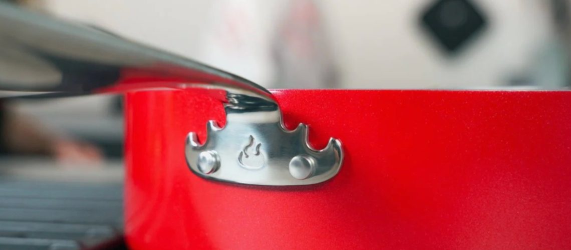 The flame on the side of the Guy Fieri's ceramic cookware pan