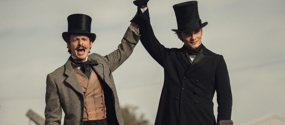 L-R: Anthony Boyle and Louis Partridge standing and shouting in a scene from Netflix's "House of Guinness"