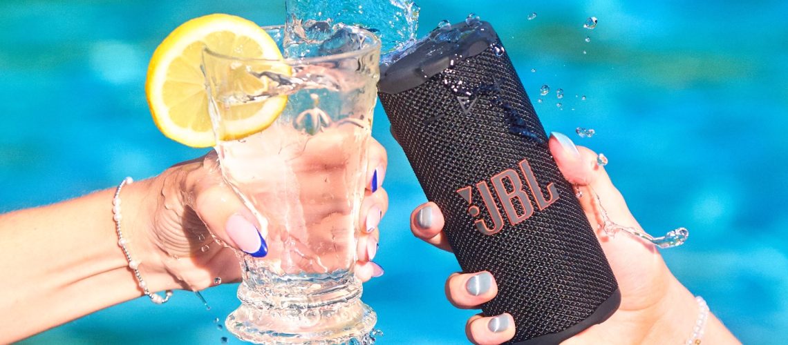JBL Grip toasting with a drink