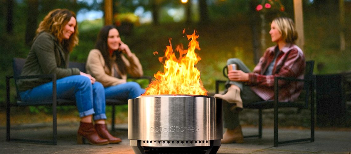 women sitting around Solo Stove Summit 24