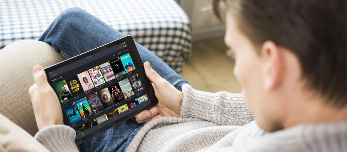 A person watching content on their tablet via Plex