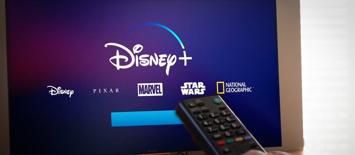Barcelona, Spain. Jan 2019: Man holds a remote control With the new Disney+ screen on TV. Disney+ is an online video streaming subscription service, set to launch in the US in September.Illustrative - Image