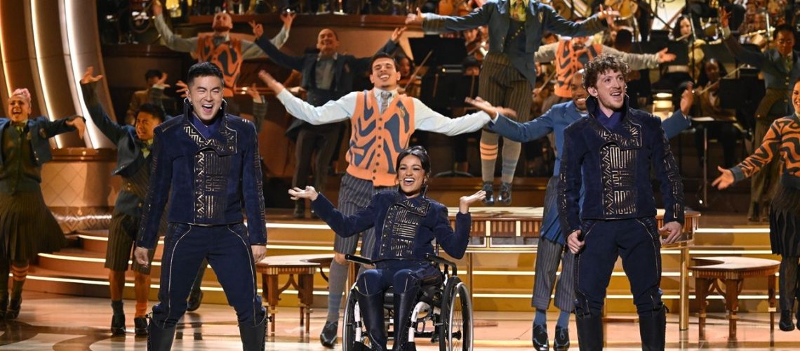 Left to right: Bowen Yang, Marissa Bode, and Ethan Slater performing "Dancing Through Life" onstage at the Dolby Theatre in LA for NBC's "Wicked: One Wonderful Night" event.