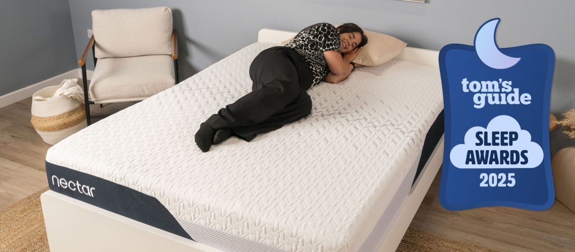 A woman lying on the Nectar Classic mattress in a bedroom, with a Tom's Guide Sleep Awards badge overlaid