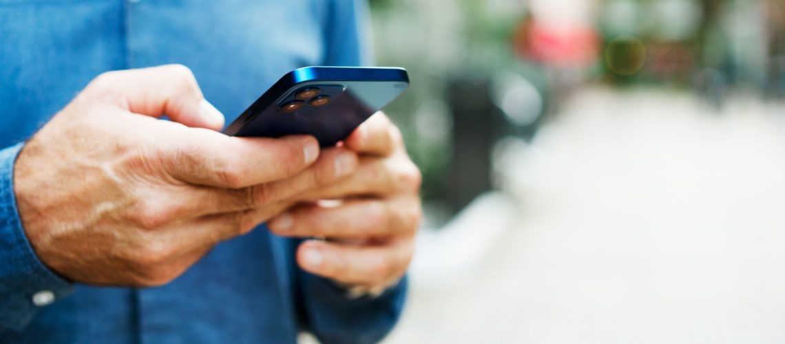 Close up of man using an iPhone