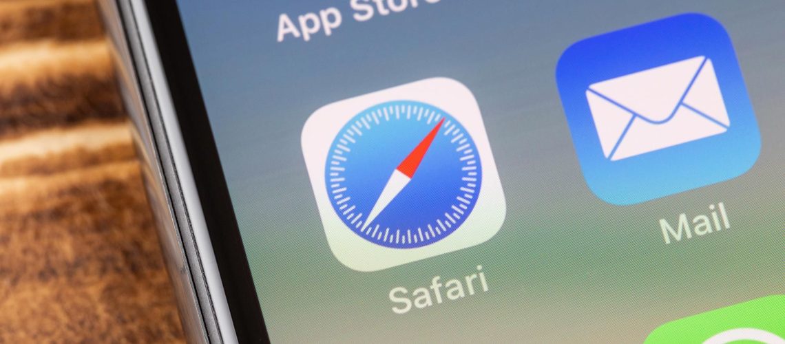 An image of an iPhone screen showing the Safari app icon in the center