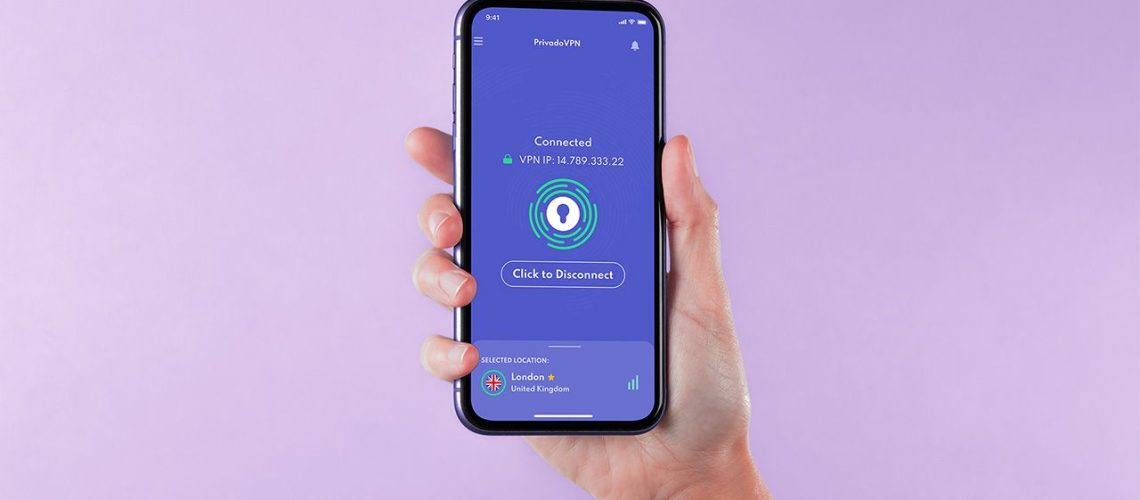 Hand holding iPhone with PrivadoVPN open on a lilac background