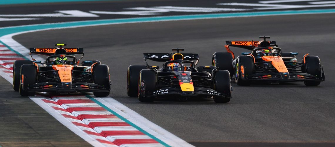 Max Verstappen of Red Bull Racing and Lando Norris and Oscar Piastri of McLaren in a row during a Formula 1 formation lap.