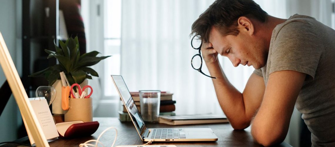 Man stressed at computer