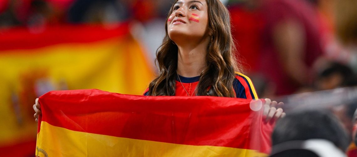A Spain fan with a flag during a FIFA World Cup 2026 soccer match.