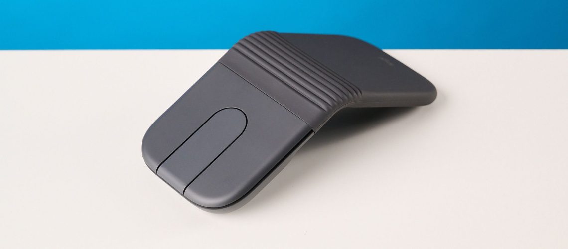 Logitech Mobi Fold mouse in graphite photographed in front of a blue background