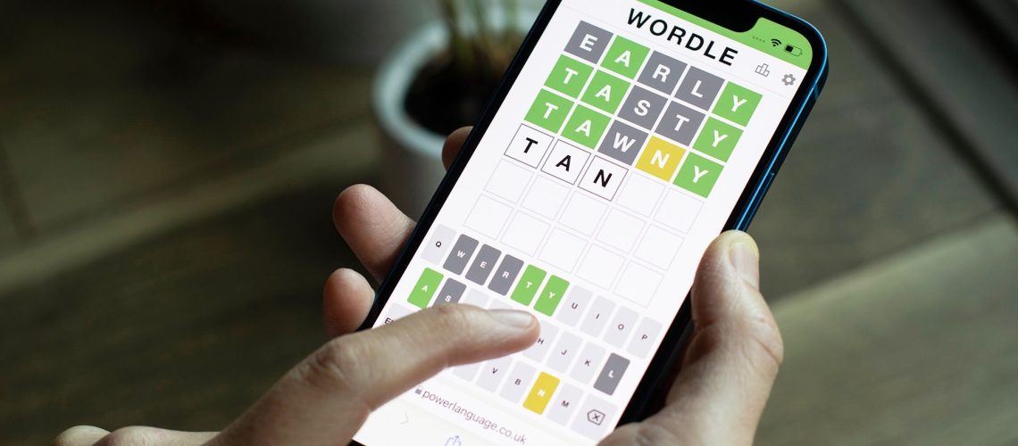 Wordle on a smartphone, held in a hand, but not using one of the best Wordle start words