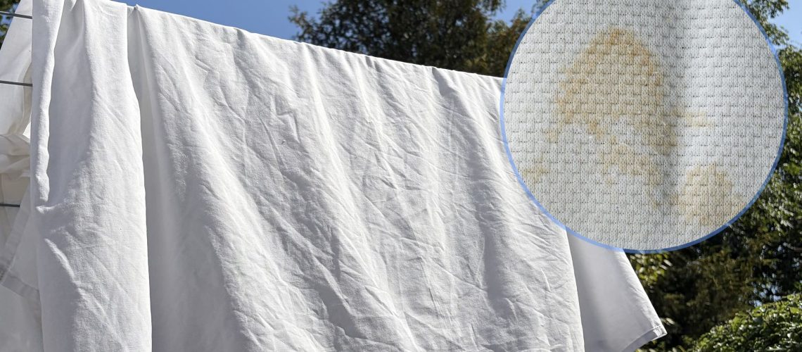 The main image shows a white duvet cover on a washing line on a sunny day. In the top right corner is an ident showing a close up of a yellow stain on bedding