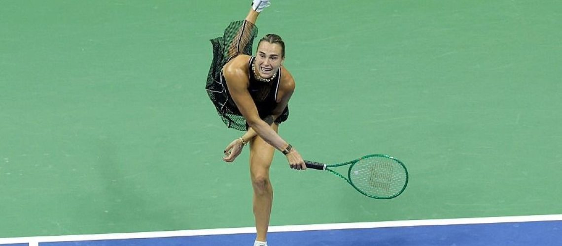 Dressed in black, Aryna Sabalenka hits a serve on court during the US Open 2026
