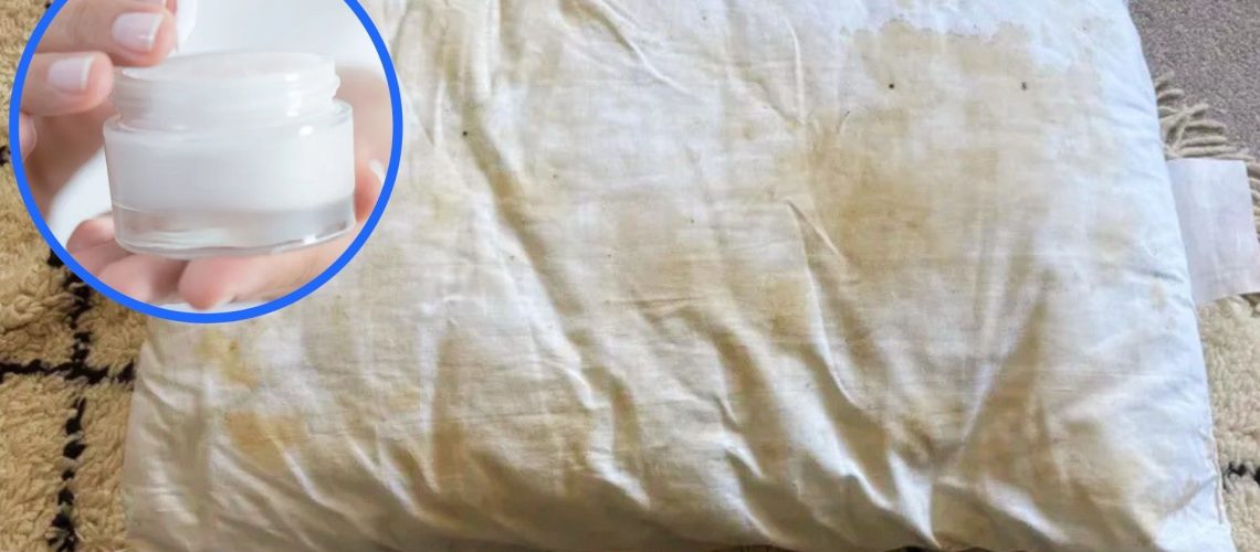 Yellow stains on pillow. In the top left foreground, there is a circular frame featuring a jar of face cream.