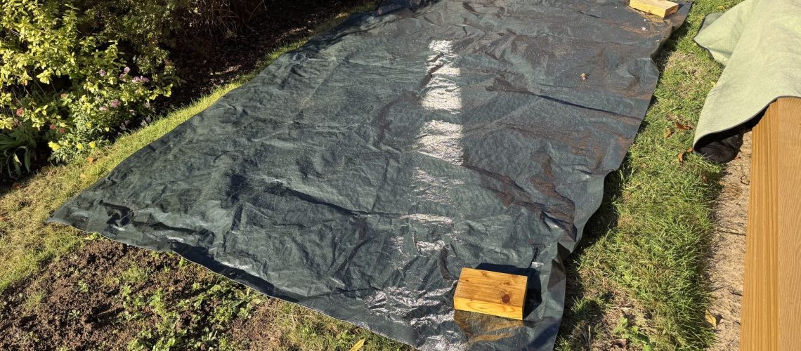 Laying out a tarp on a lawn