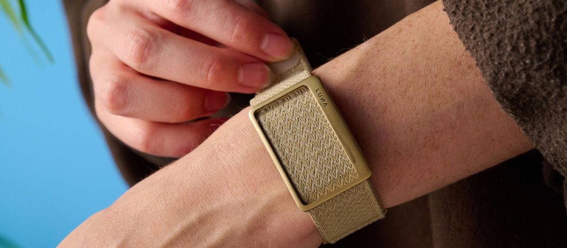 the luna band in beige photographed with the blue tom's guide background being worn by the author