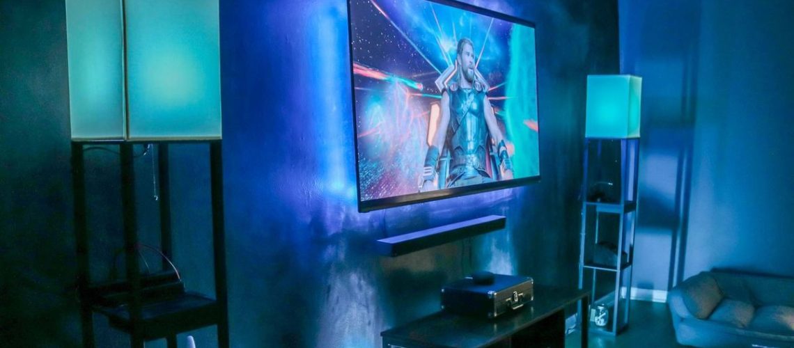 A TV showing Thor Ragnarok with smart lights synced with what is on the screen