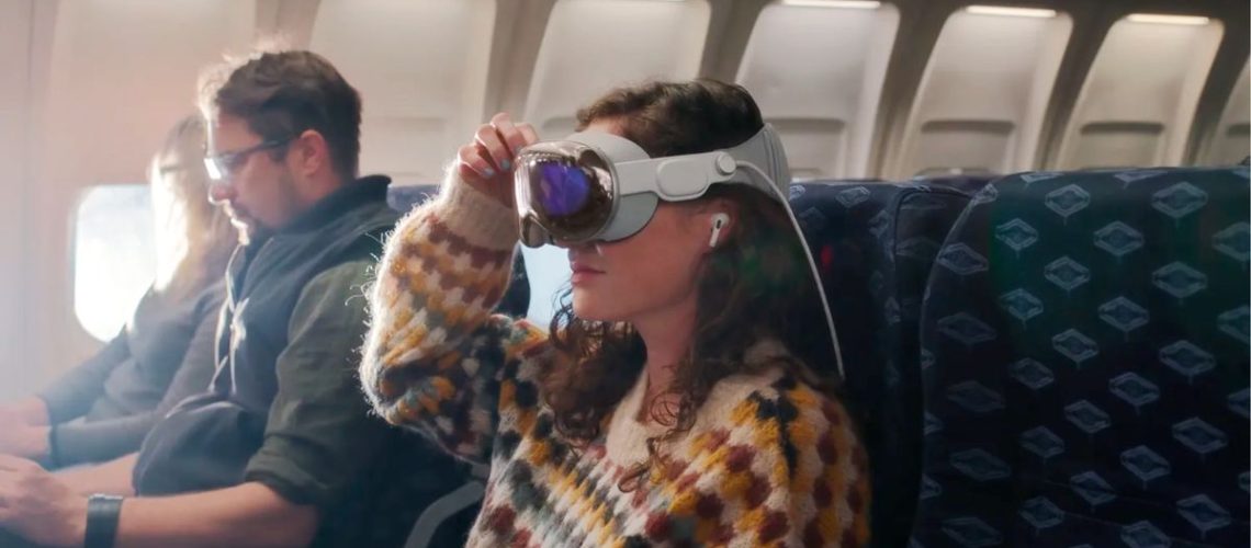 woman using apple vision pro on a plane