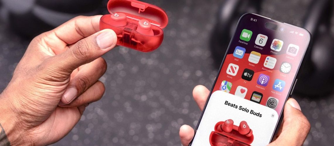 The Beats Solo Buds next to an iPhone in a gym setting.