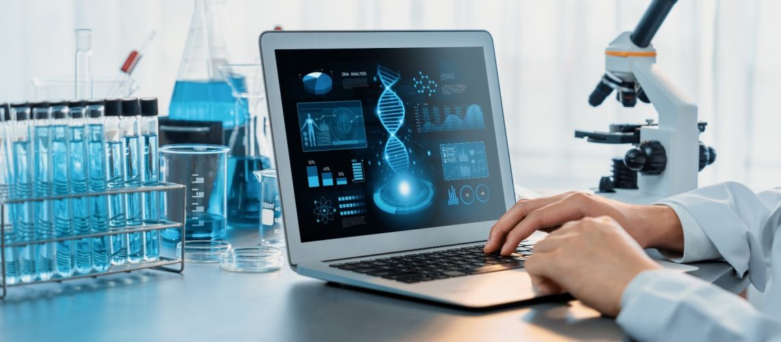 Scientist working on advance biotechnology computer software to study or analyze DNA data after making scientific breakthrough from chemical experiment on medical laboratory.