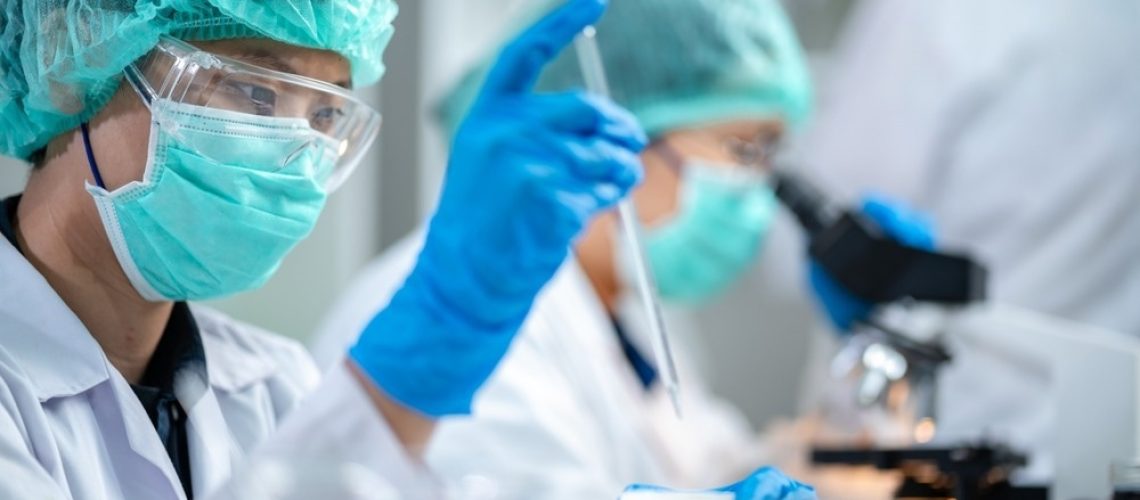 Scientists are working on a sample of milk in a biotechnology laboratory