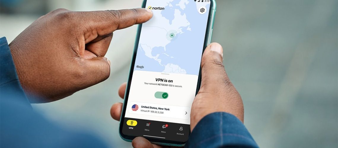 Person holding smartphone with Norton VPN app open and connected to a US server