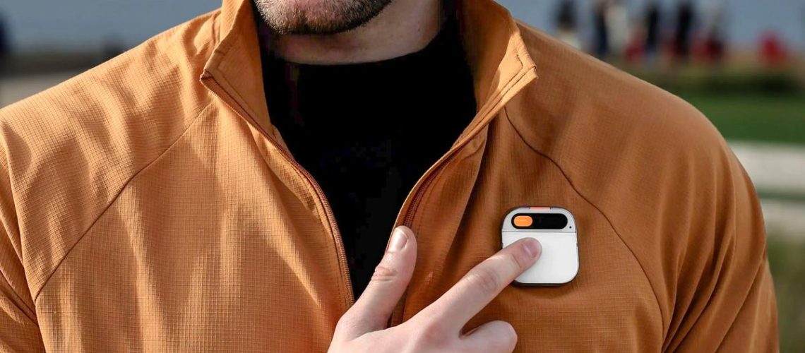 A person tapping on the Humane AI Pin worn on their jacket