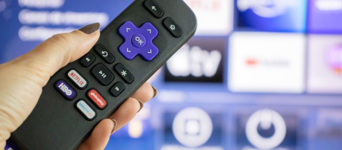 Roku remote in front of TV