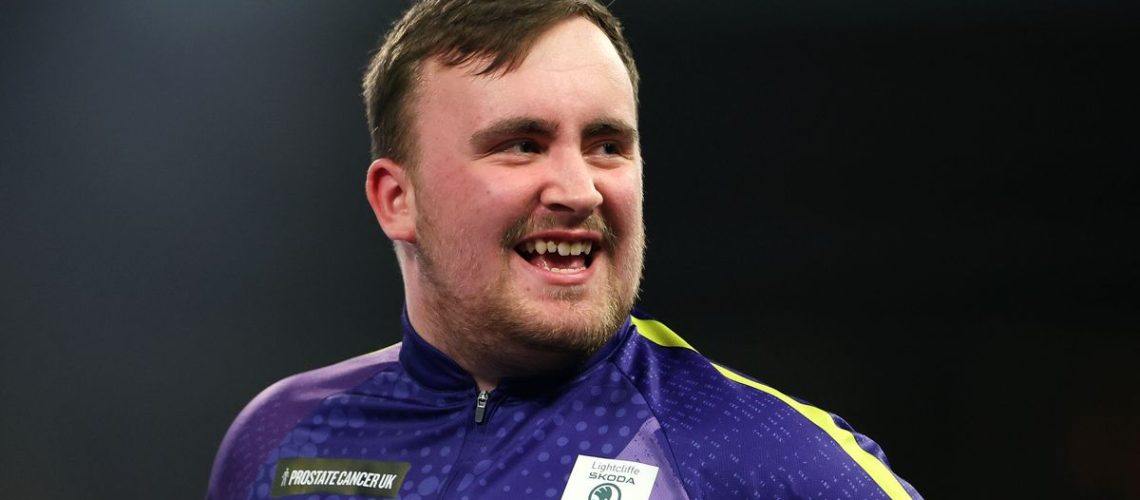 Luke Littler of England smiles at the oche ahead of the World Matchplay Darts live stream 2024