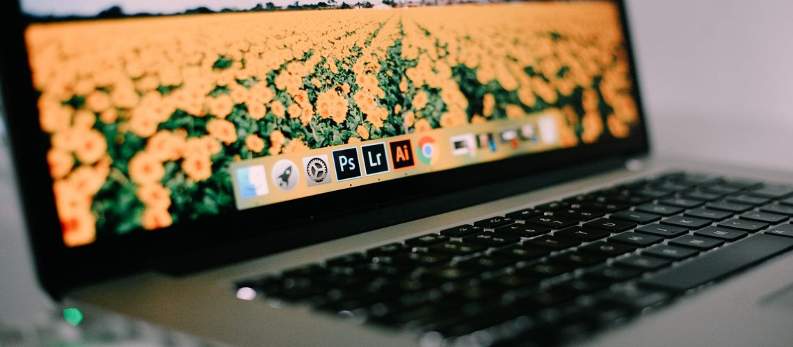 best alternatives to illustrator - MacBook screen displaying Adobe logos