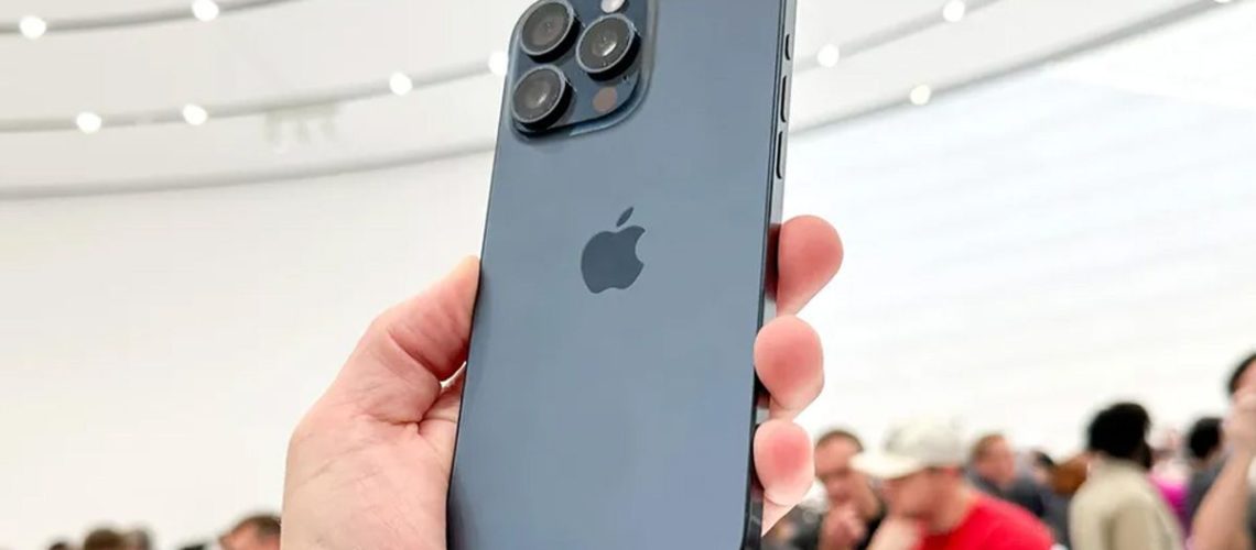 Silver iPhone model being held at an event.