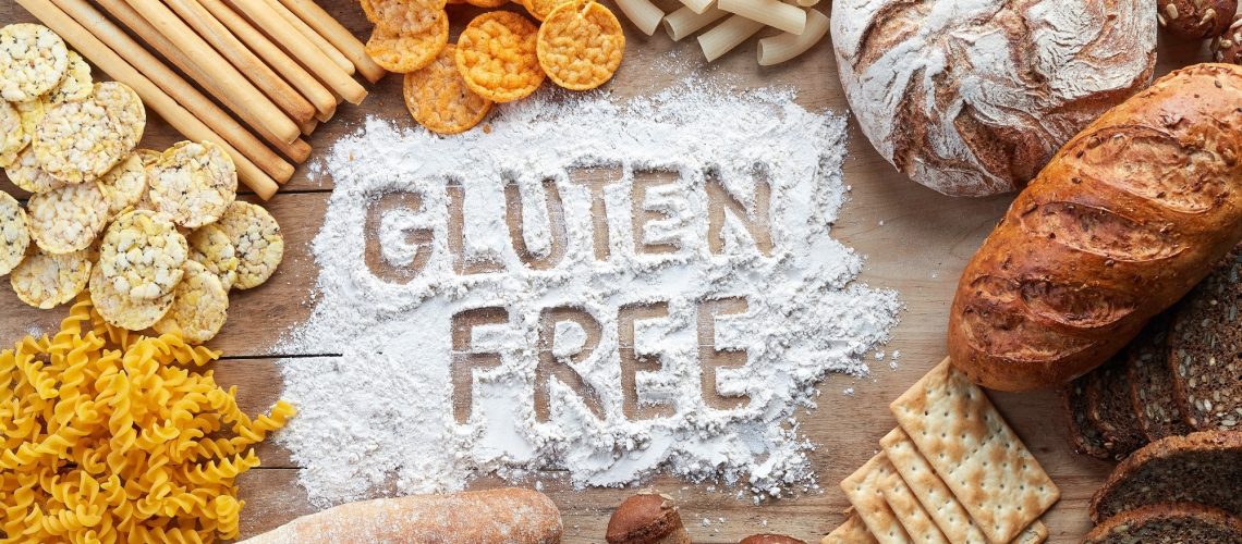 Gluten free food. Various pasta, bread and snacks on wooden background from top view