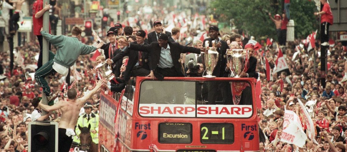 Manchester United – the stars of new Amazon MGM Studios documentary 99 – celebrate winning the treble as the jubilant team make their way through Manchester during an open top bus parade. Teddy Sheringham and Dwight Yorke on 27th May 1999