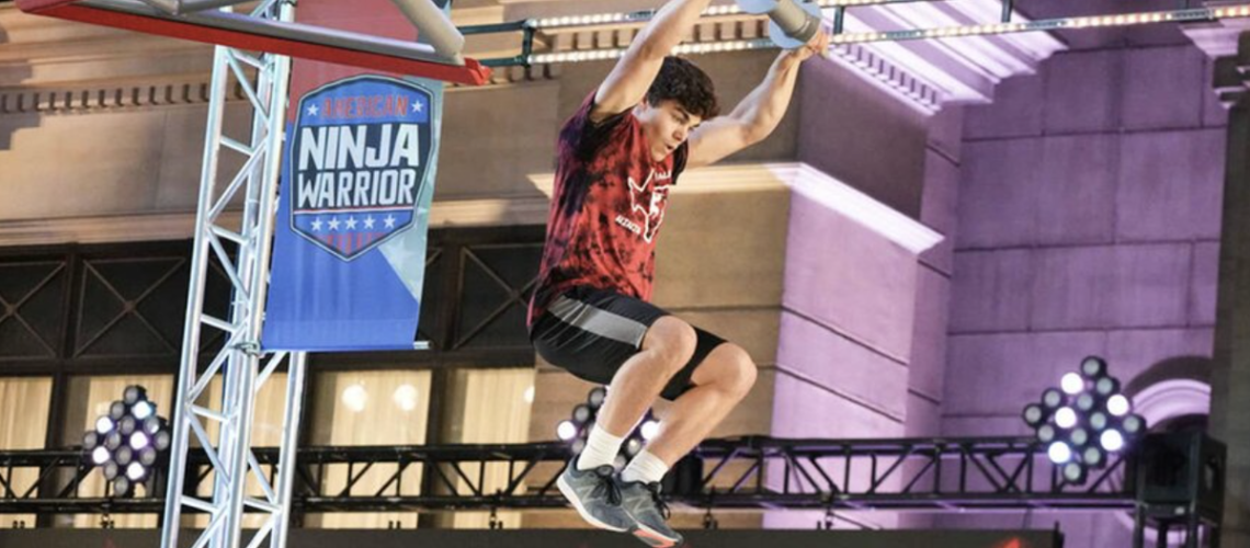 Vance Walker hanging off a pulley on American Ninja Warrior season 16