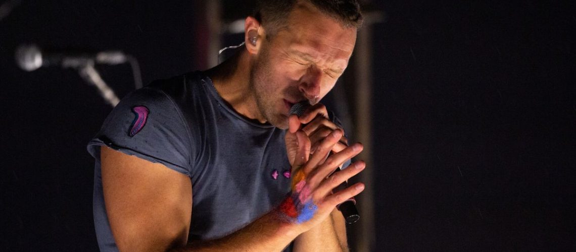 Chris Martin sings in close-up while on the Pyramid Stage at Glastonbury