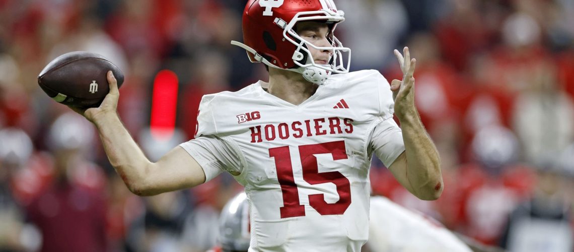 Fernando Mendoza of the Indiana Hoosiers throws a pass during a college football game.