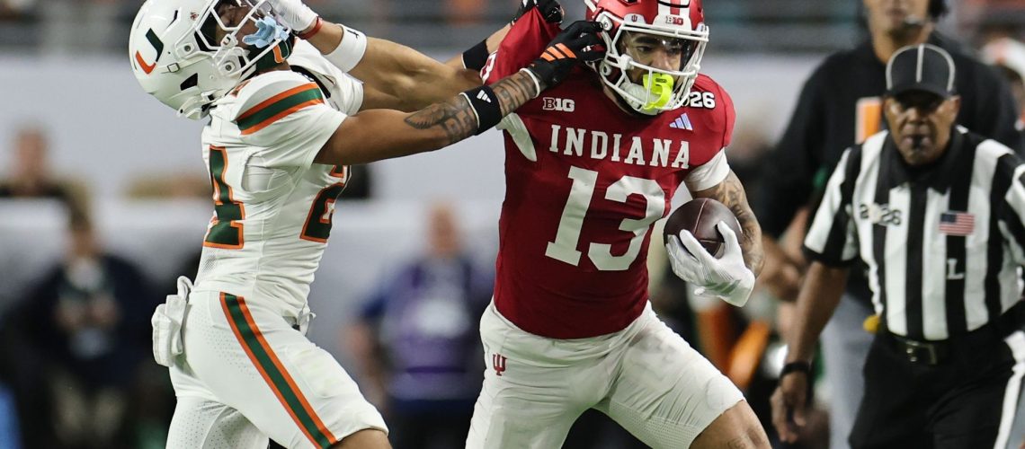 Senior Bowl hopeful Elijah Sarratt of the Indiana Hoosiers stiffarming Ethan O'Connor of the Miami Hurricanes in the 2026 CFP National Championship game