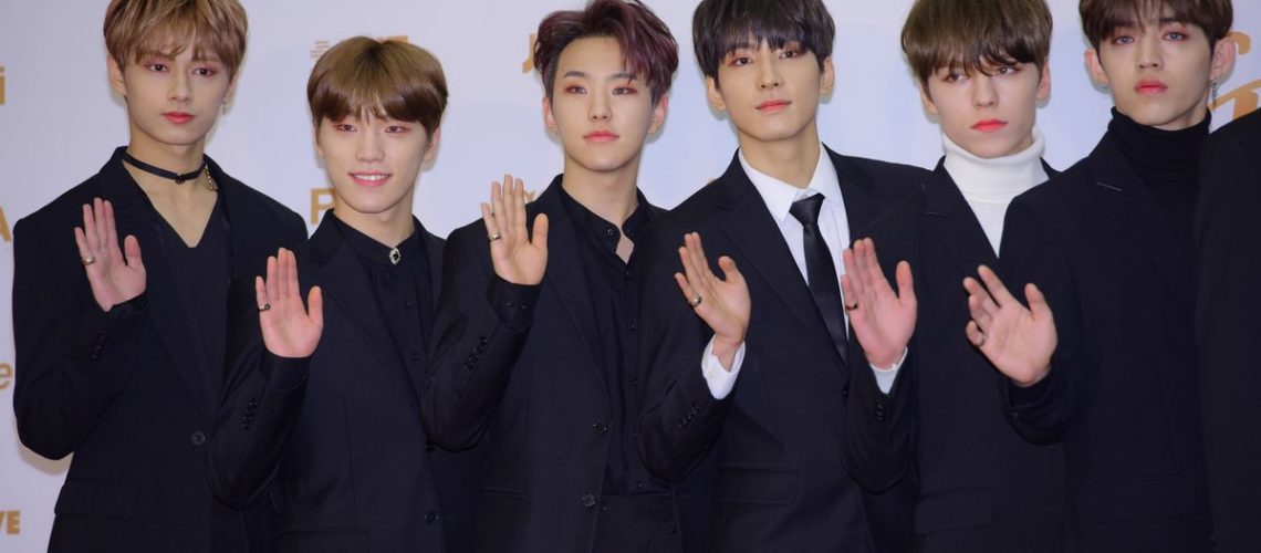 Jun, Dino, Hoshi, Wonwoo, Vernon and S.Coups of SEVENTEEN in black evening suits.