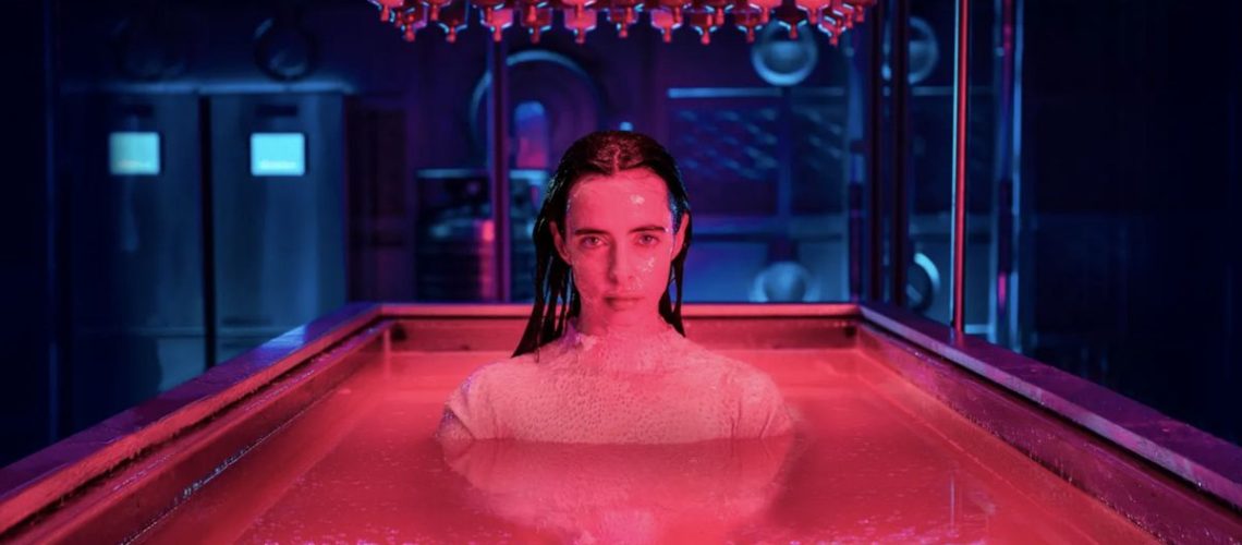 Lucy (Krysten Ritter) in a pink bath in Orphan Black: Echoes.