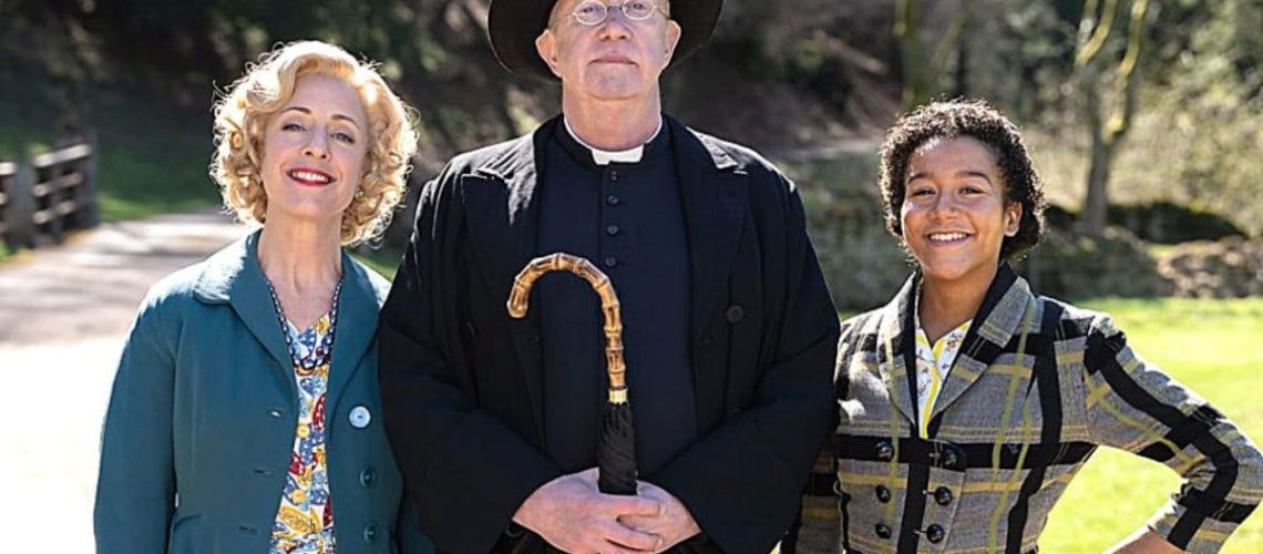 British actor Mark Williams dressed in black priest