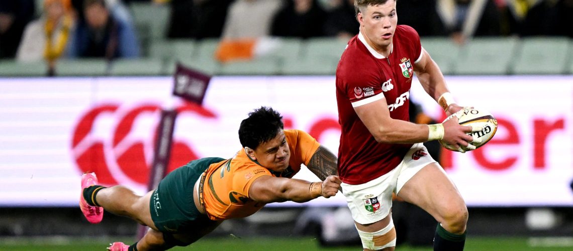 British and Irish Lions' Huw Jones (R) runs away from Australia's Len Ikitau during the second rugby Test match at the Melbourne Cricket Ground (MCG) on July 26, 2025.