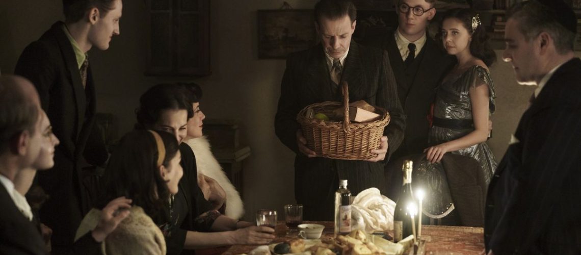 Bel Powley and Joe Cole as Miep and Jan Gies at a candlelit supper in A Small Light