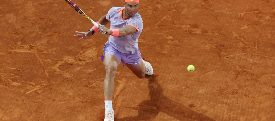 Rafa Nadal plays a shot on clay court