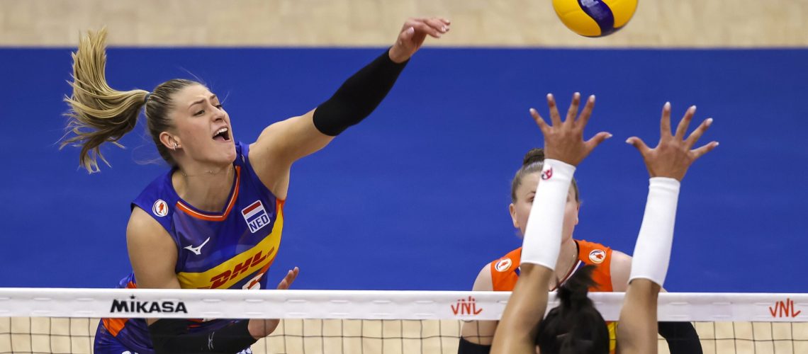 Elles Dambrink (L) of Netherlands spikes the ball against Helena Cazaute (R) and Amandha Sylves (R